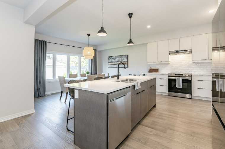 Meadow Heights model home — bright open-concept kitchen with island, pendant lights and dining area