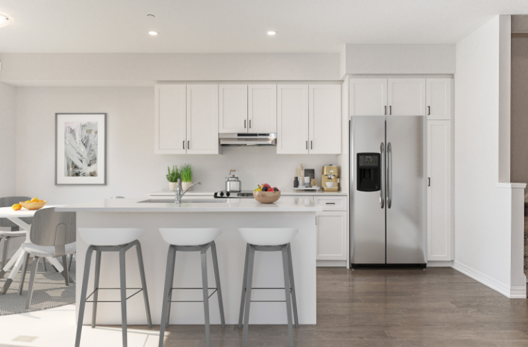 Bromley Gardens model home — bright open-concept kitchen with island and stainless appliances